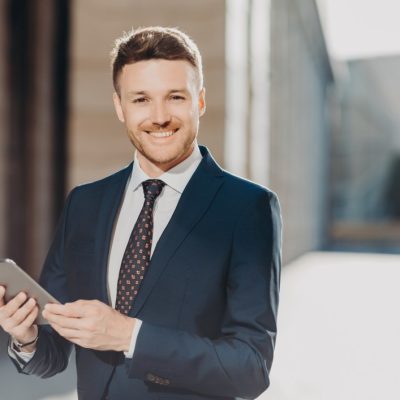 portrait-of-handsome-male-with-positive-expression-updates-software-on-tablet-computer-connected-to_t20_XvLyVl.jpeg